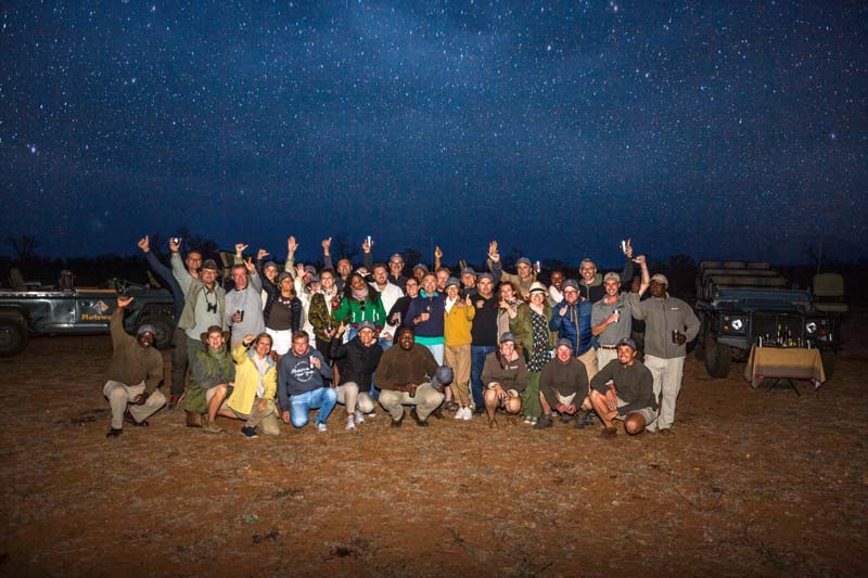 group photograph taken in the bush at night